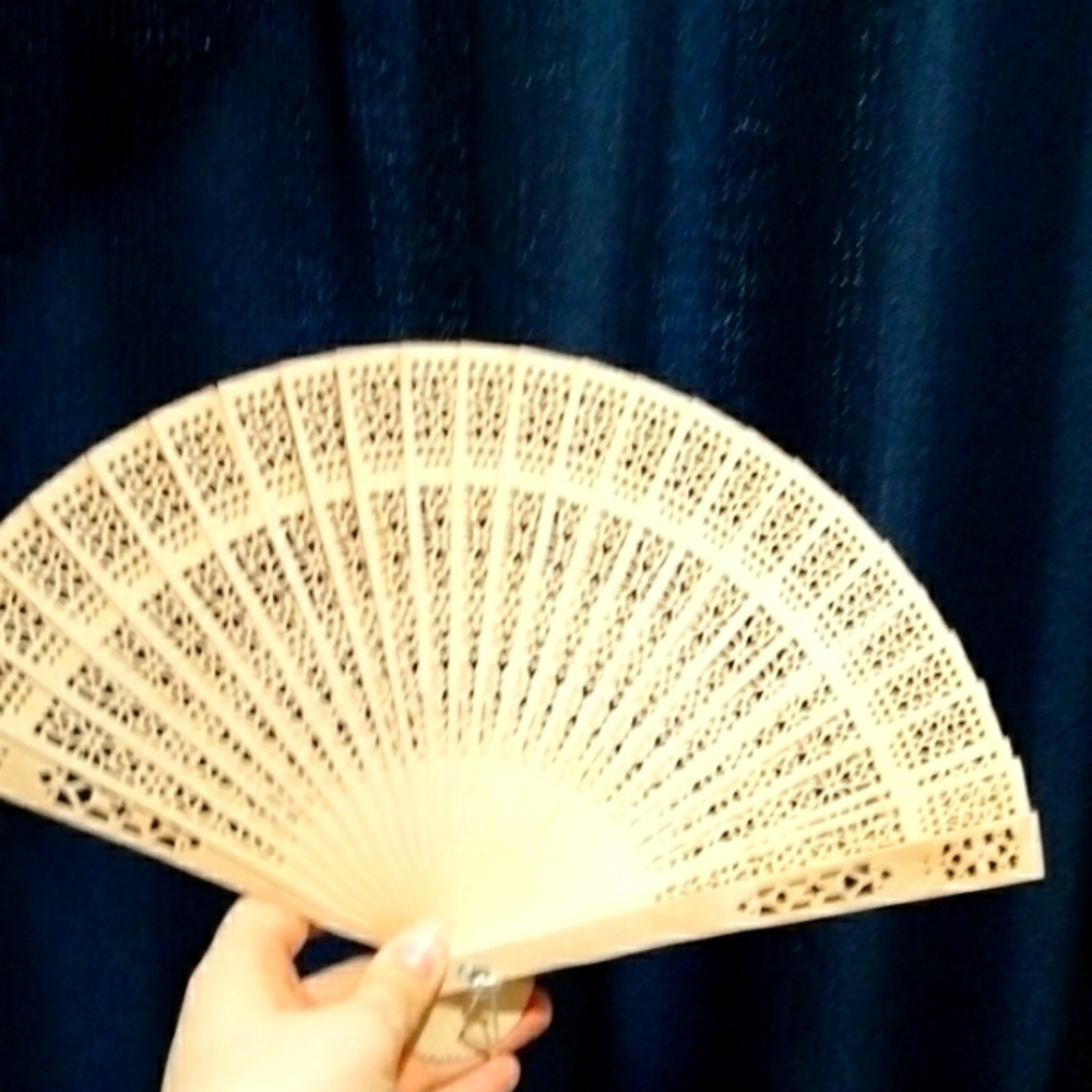 A wooden hand fan